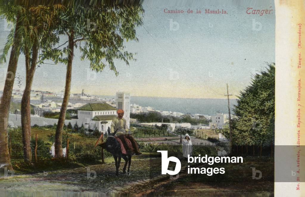 Man riding a donkey on a road, Tangier (coloured photo)