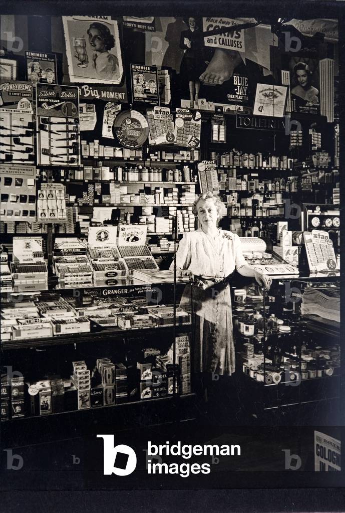 Woman shopkeeper in a tobbaconist's (b/w photo)
