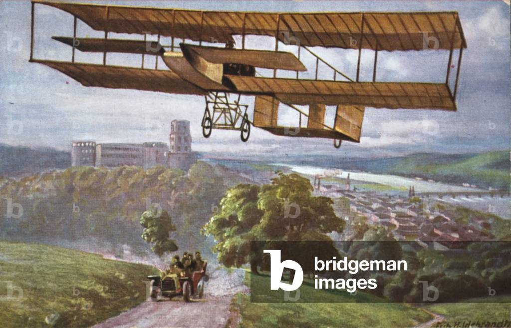 Farman biplane flying above a town, c1910. (colour litho)