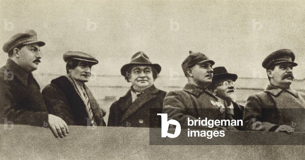 Soviet leaders Joseph Stalin, Mikhail Kalinin, Kliment Voroshilov, and Lazar Kaganovich with Bulgarian and French Communists Georgi Dimitrov and Henri Barbusse commemorating the Russian Revolution on the tribune of Lenin's mausoleum, Moscow, 7 November 19 (b/w photo)