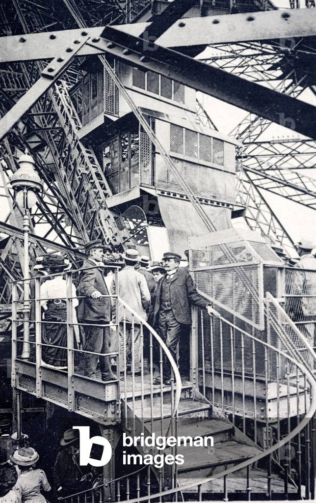 Tourists visiting the Eiffel Tower, Paris, France, c1910 (b/w photo)