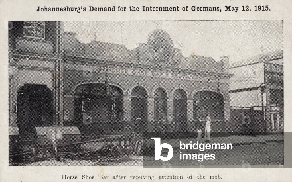 Postcard depicting the Horse Shoe Bar after receiving attention of the mob (b/w photo)