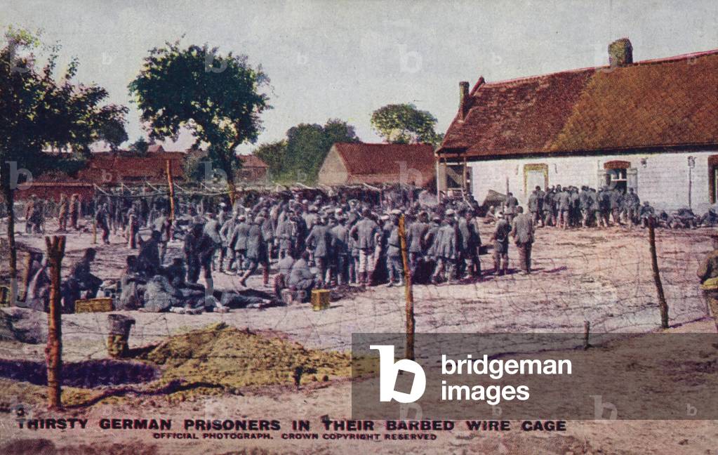 Thirsty German prisoners in their barbed wire cage, World War I (coloured photo)