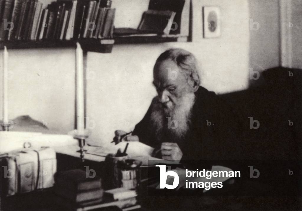 L N Tolstoi working in his study, Yasnaya Poliana, 1909 (b/w photo)