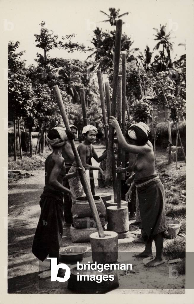 Pounding rice in Malay (b/w photo)