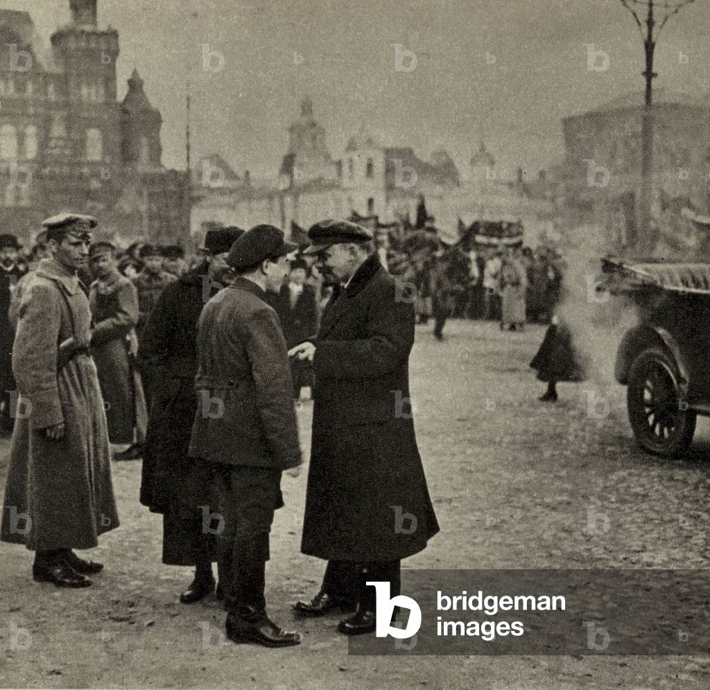 Lenin chats with V M Zagorsky, Secretary of the Moscow Committee of the Russian Communist Party, during the May Day Demonstration in Red Square, Moscow, 1 May 1919 (b/w photo)
