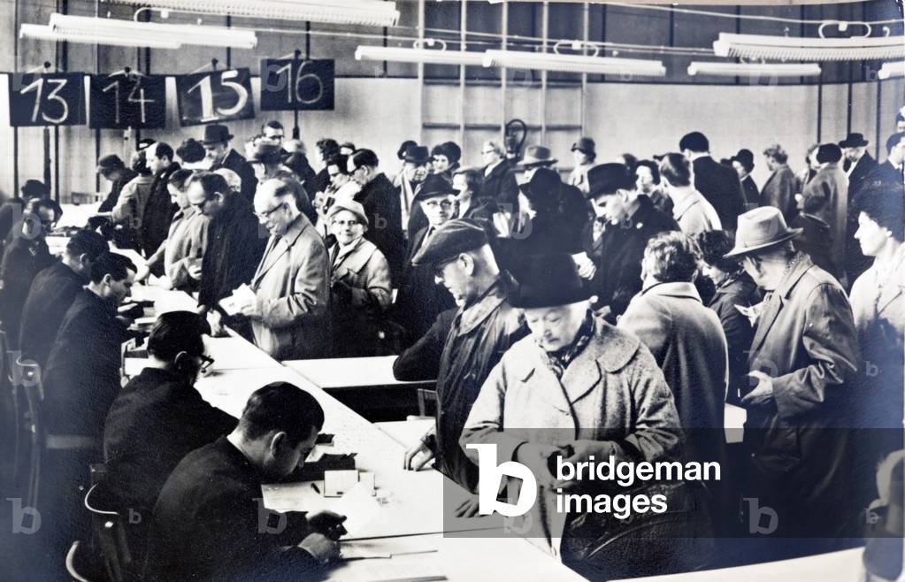 East German citizens queuing to obtain permits to visit relatives in the West (b/w photo)
