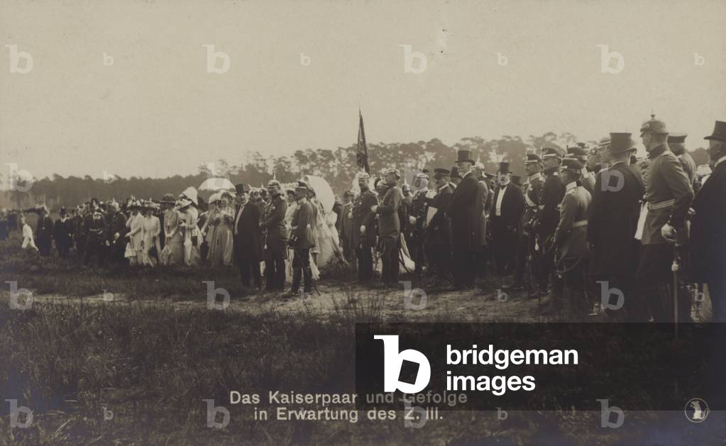 Kaiser Wilhelm II and Empress Victoria Augusta of Germany and their entourage awaiting the arrival of Zeppelin LZ III (b/w photo)