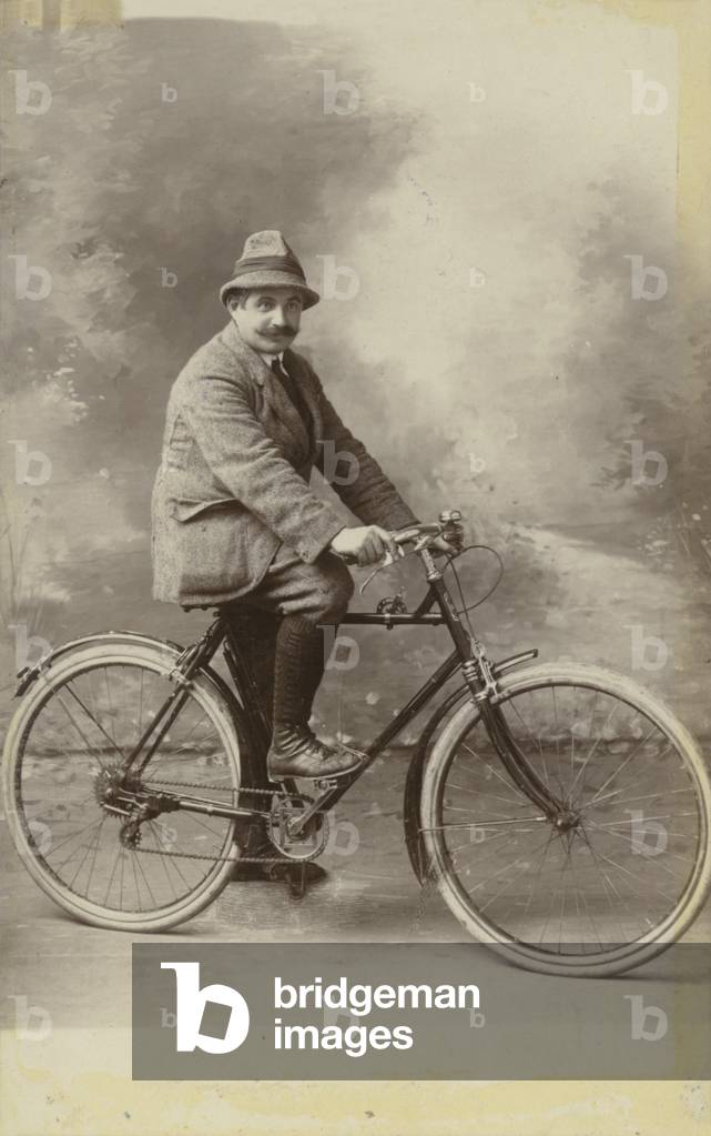 Man on bicycle (b/w photo)