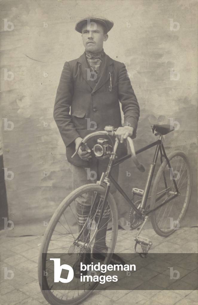 Man wearing cap with bicycle (b/w photo)