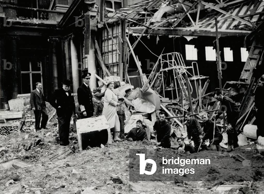 King George VI amd Queen Elizabeth, together with Winston Churchill, surveying bomb damage, presumably to Buckingham Palace (b/w photo)