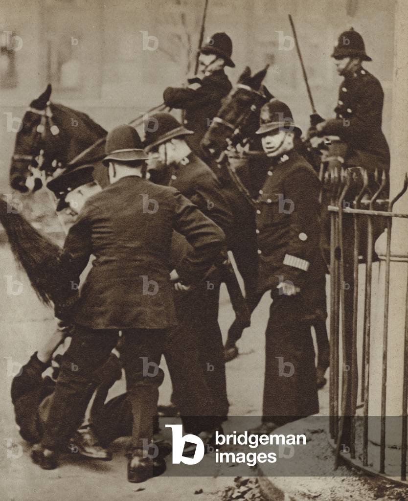 Police detaining a rioter during a hunger march by unemployed workers in London, 1932 (b/w photo)