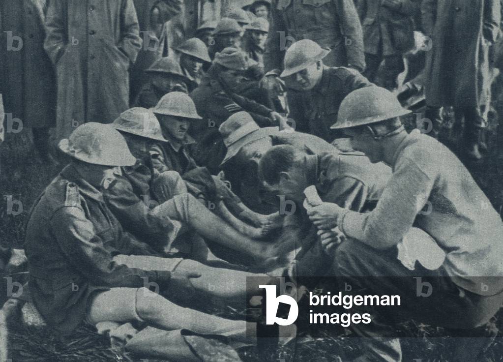 Caring for the Feet of the Men who have been for Several Days in the Front Line (b/w photo)