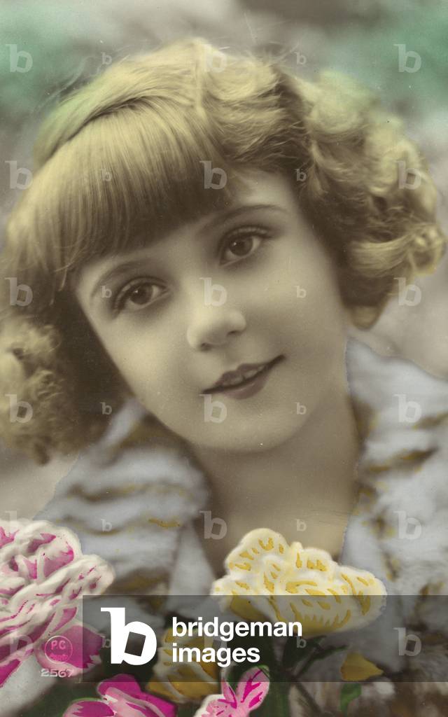Young girl posing with flowers (coloured photo)