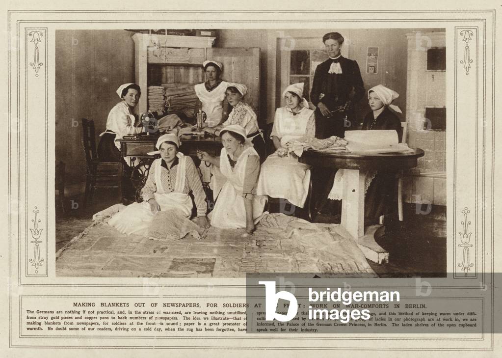 Making blankets out of newspapers, for soldiers at the front, work on war-comforts in Berlin (b/w photo)