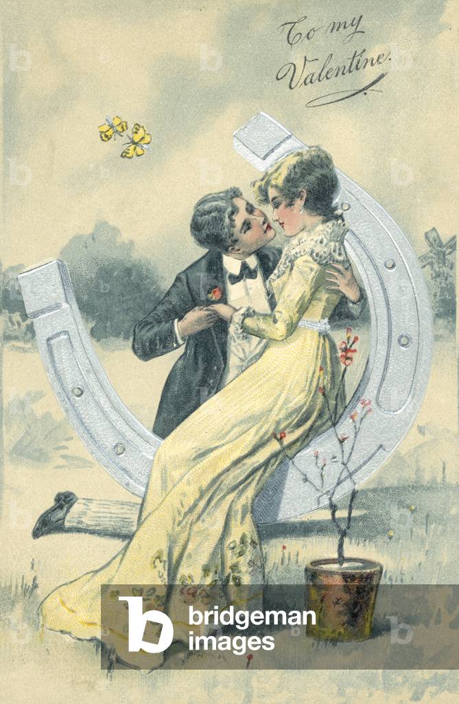 Girl and boy, about to kiss, while sitting on a large horse shoe, 1900s (colour litho)