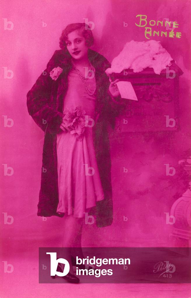 Elegant girl about to post New Year's greeting card (photo)