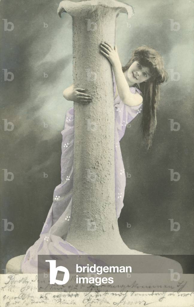 Girl looking round a pillar (colour photo)