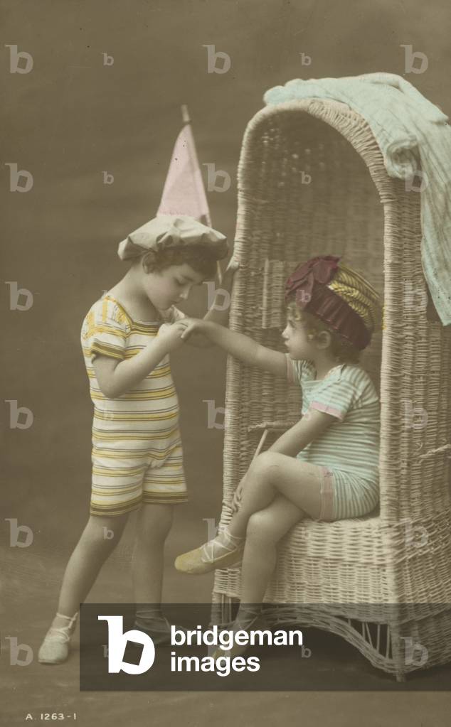 Young boy kissing the hand of a little girl (coloured photo)