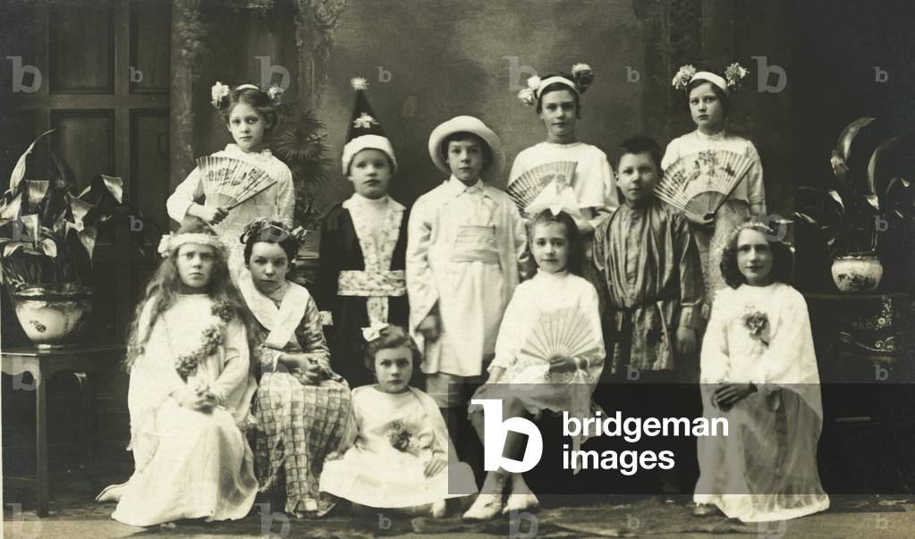 Group of children dressed up in various costumes (b/w photo)