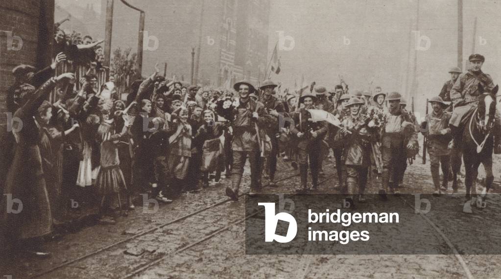 British troops of the Liverpool Irish receiving a warm welcome from the people of the recaptured town of Lille, World War I, 18 October 1918 (b/w photo)