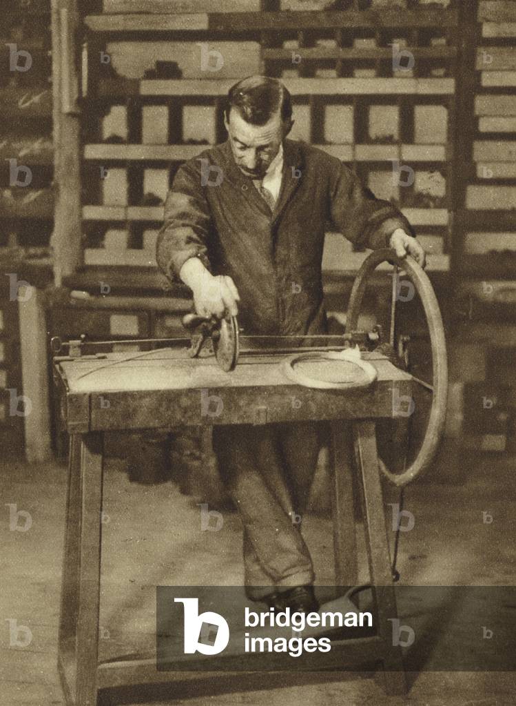 Winding wire into springs for spring-locks at a London locksmiths (b/w photo)