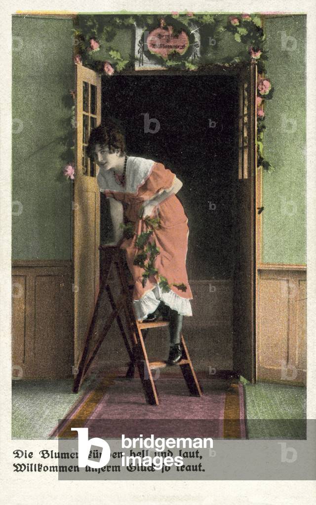 Pretty girl putting up floral decorations (colour photo)