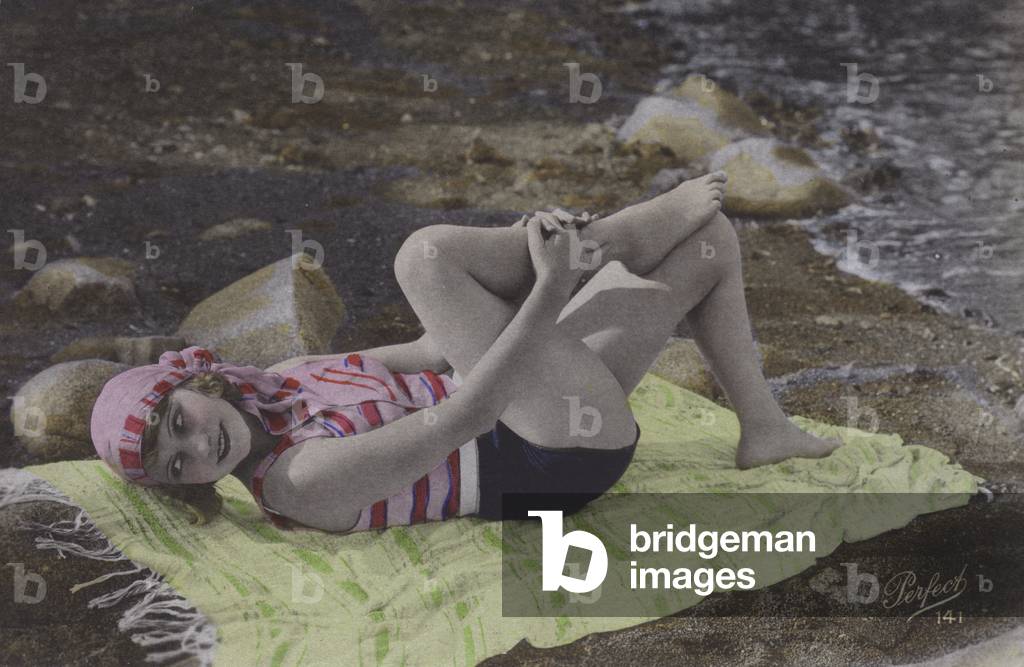 Girl lying on towel on beach (coloured photo)