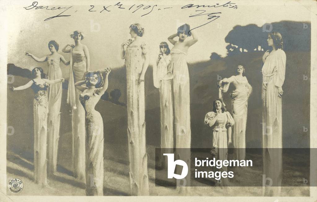 Women on stilts dressed as asparagus (b/w photo)