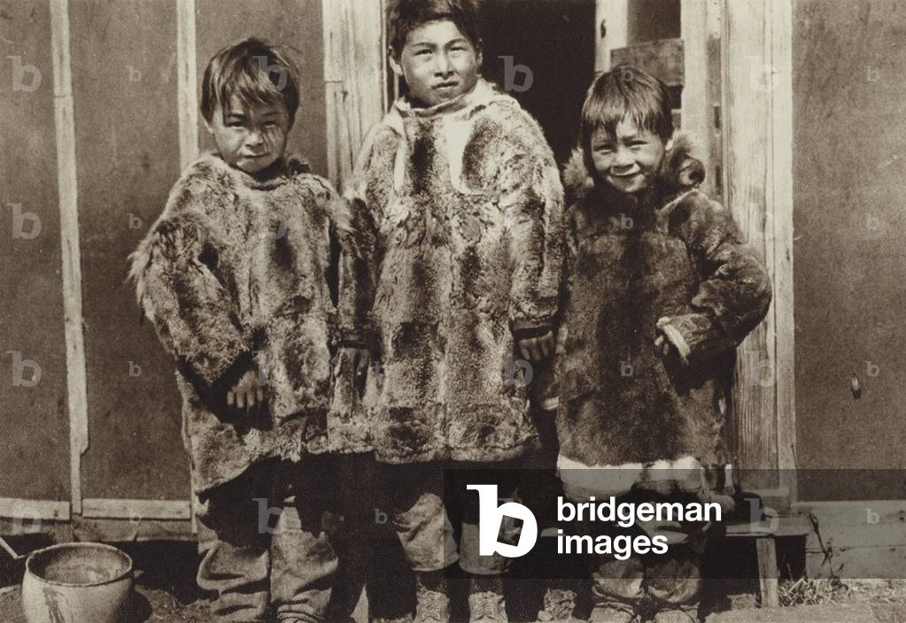 Inuit children wearing coats made from the skins of seals hunted by their father (b/w photo)