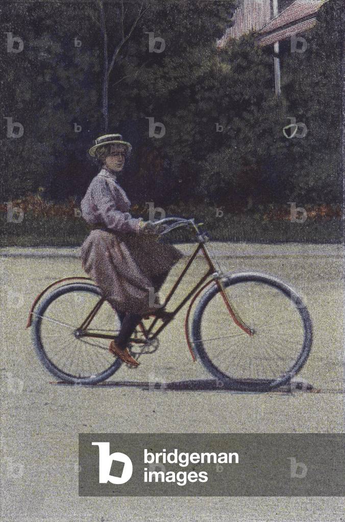 Woman riding a bicycle (colour photo)