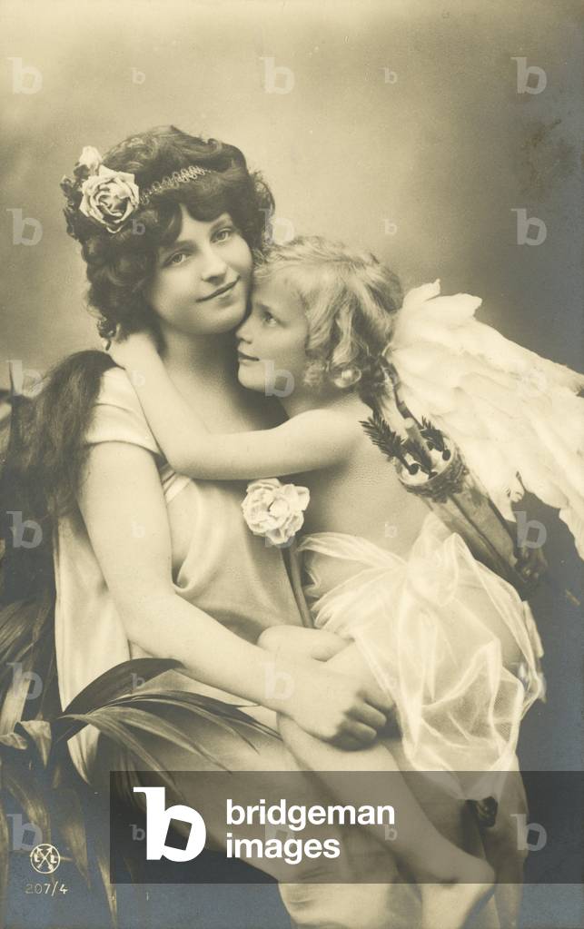 Pretty girl with angel on her knee (b/w photo)