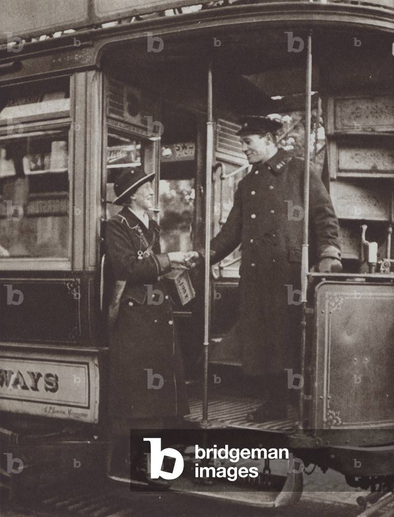 British woman who worked as a tram conductor during the First World War saying goodbye to her driver after her final shift, 1919 (b/w photo)