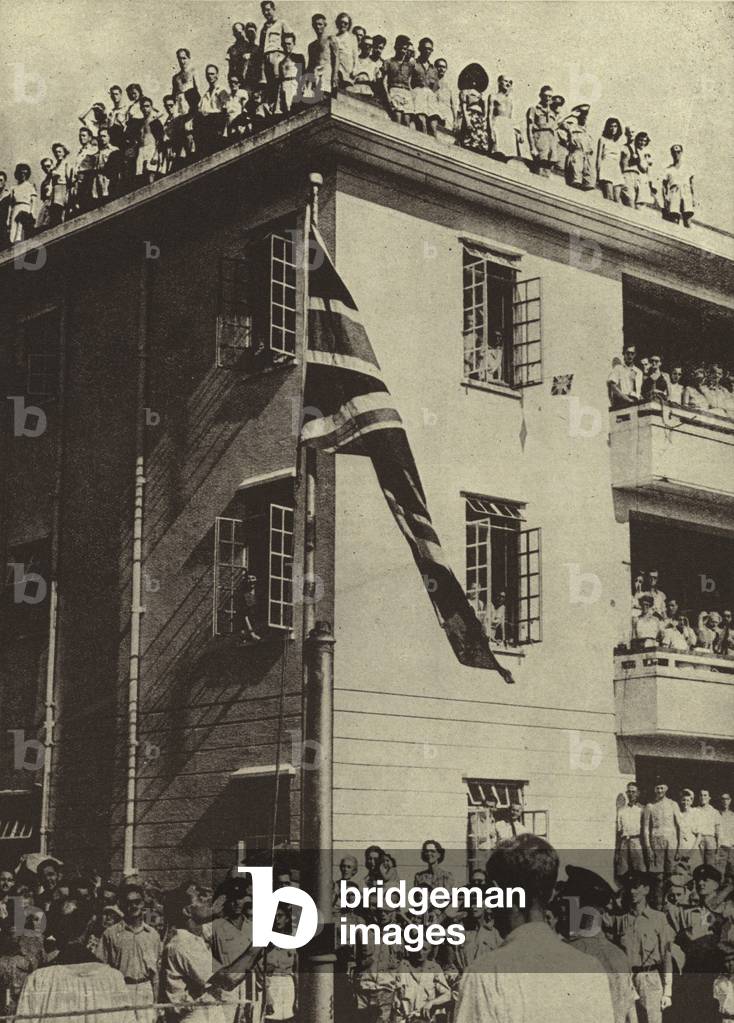 Former internees of the Japanese singing God Save the King after liberation of Hong Kong by the British, World War II, September 1945 (b/w photo)
