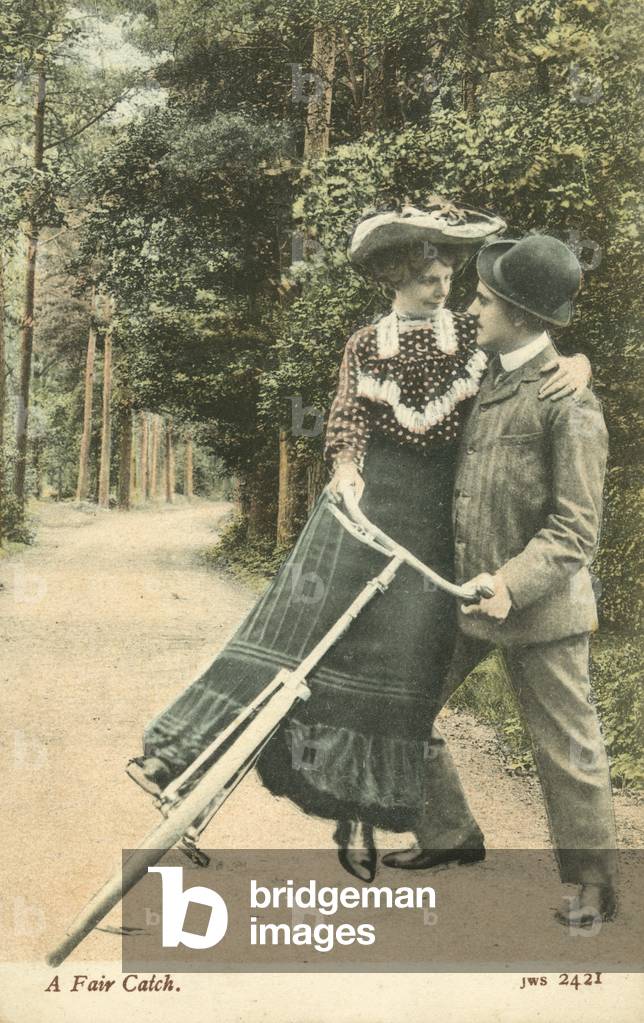 Woman falling off her bicycle into a man's arms (colour photo)
