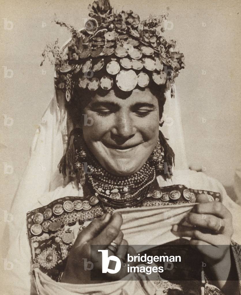 Yugoslavian peasant bride displaying her dowry in the form of gold pieces sewn into her costume (b/w photo)