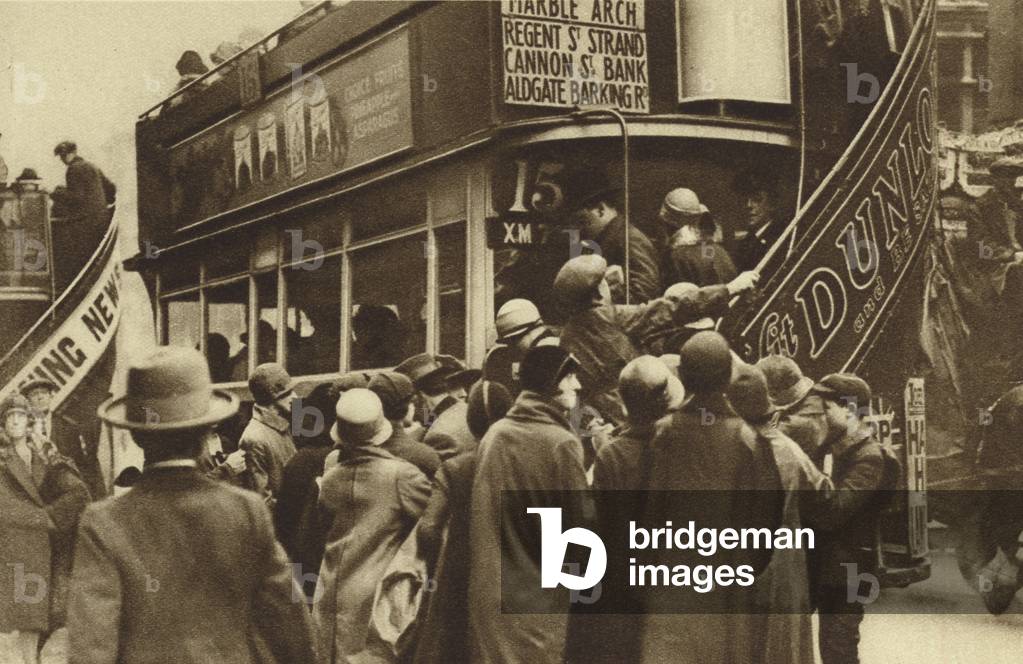Herding passengers onto a bus at Ludgate Hill, City of London (b/w photo)