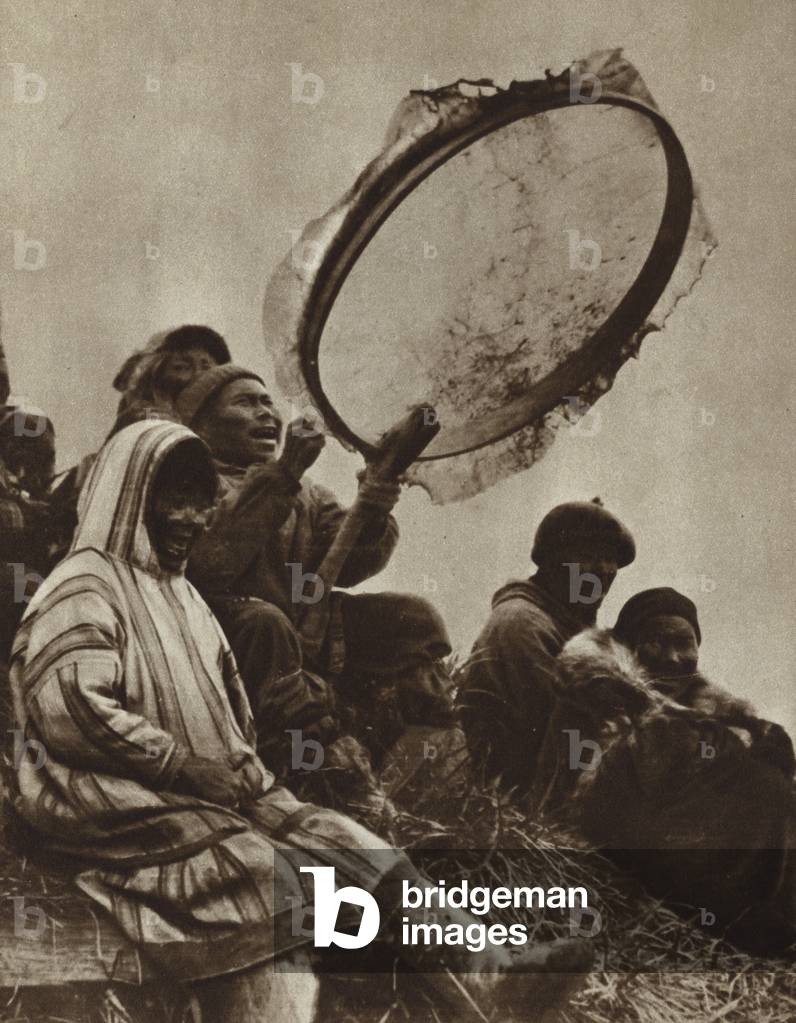 Playing a large tambourine in Mongolia (b/w photo)