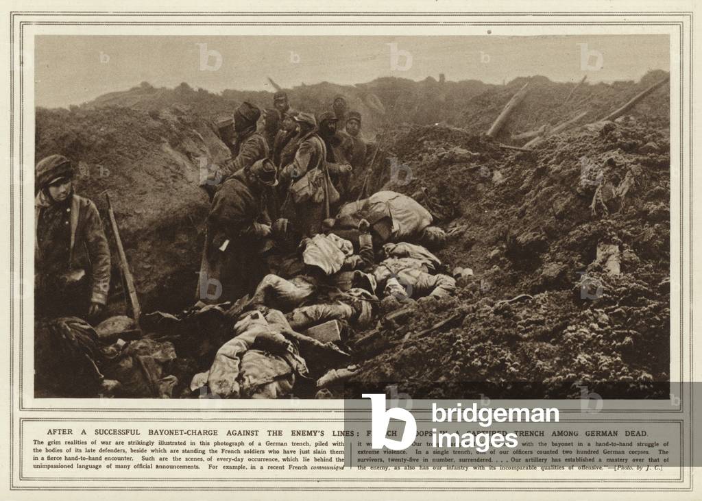After a successful bayonet-charge against the enemy's lines, French troops in a captured trench among German dead (b/w photo)