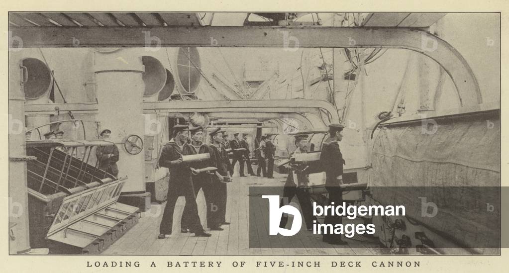 Loading a battery of five-inch deck cannon (b/w photo)