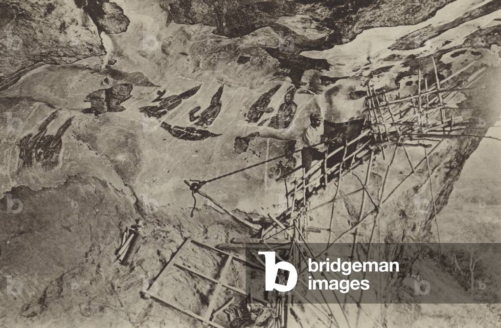 Ruined Cities of Ceylon: Copying the Frescoes of Sigiri (b/w photo)