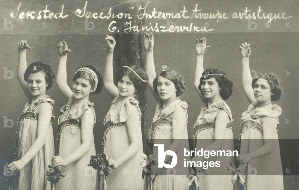 Troope of young female dancers, smiling (b/w photo)