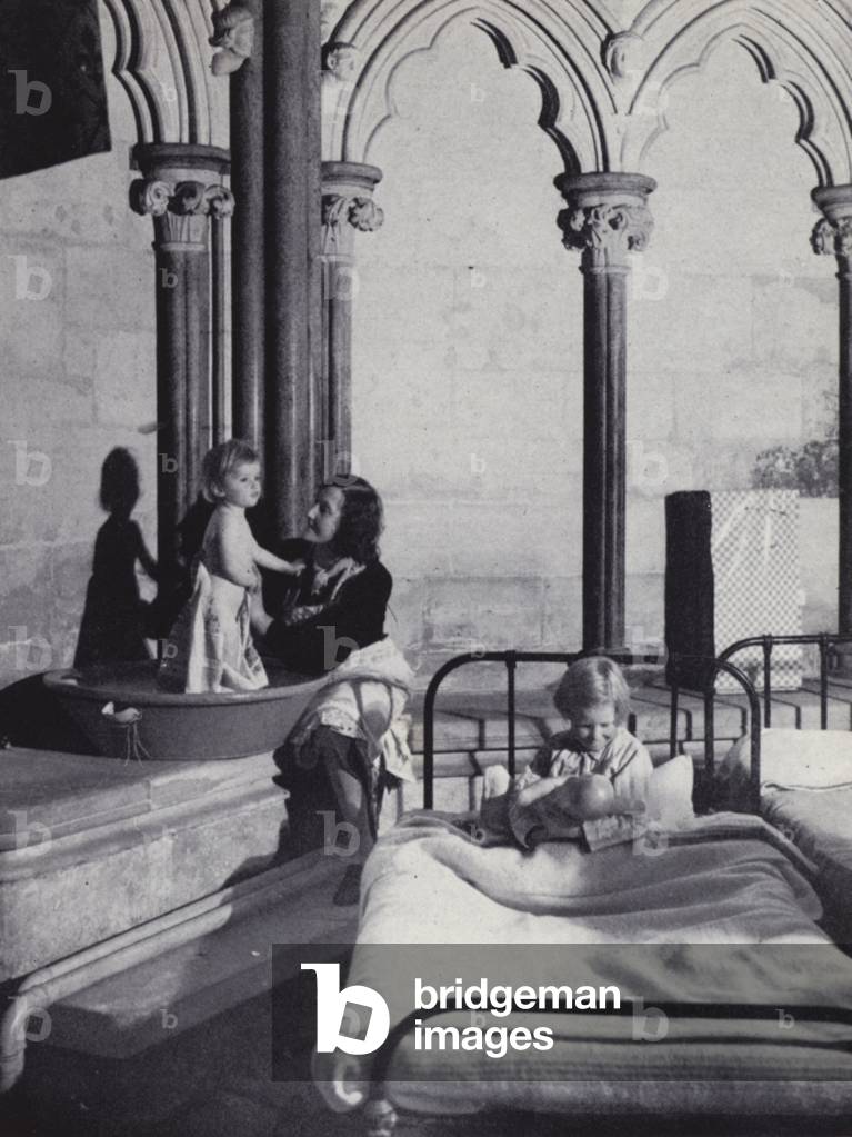Bath night for evacuees in a cathedral in Southern England (b/w photo)