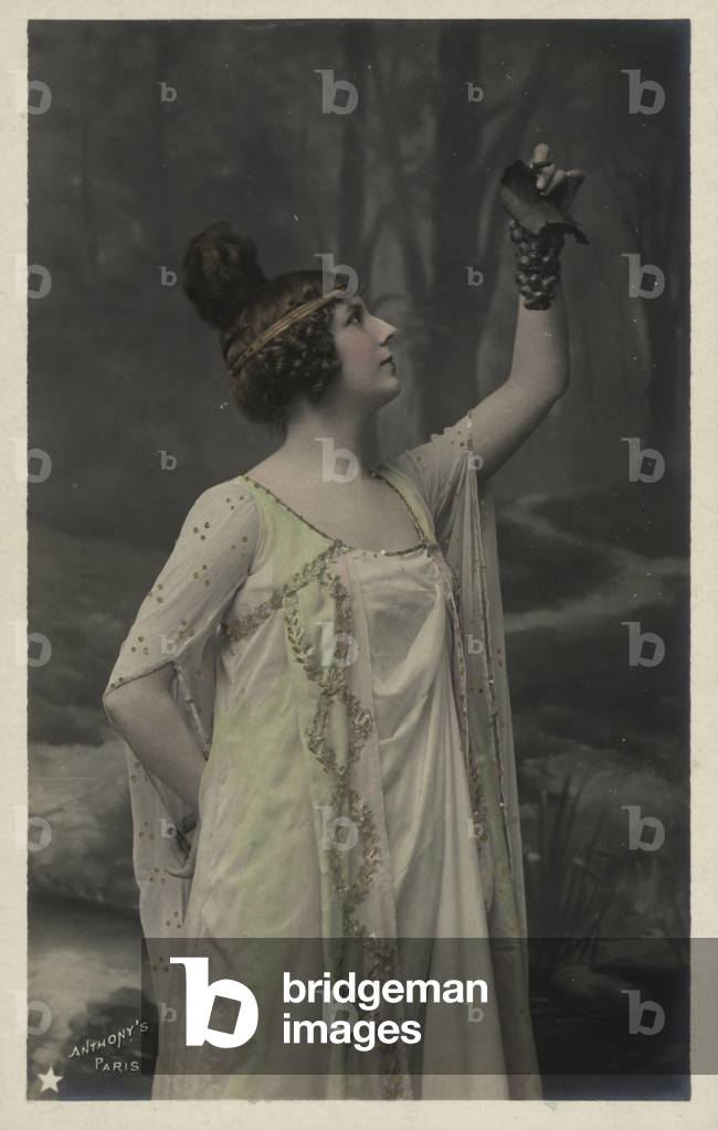 Woman with bunch of grapes (colour photo)