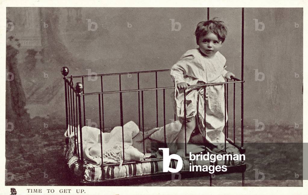 Little boy in a crib (b/w photo)