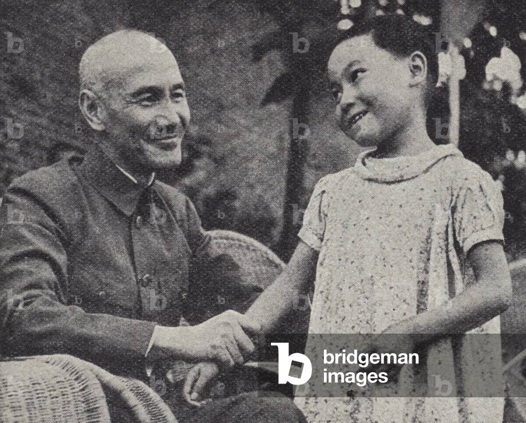 Chinese leader Generalissimo Chiang Kai-shek with a young orphan girl at Chongqing, China, World War II, 21 July 1943 (b/w photo)