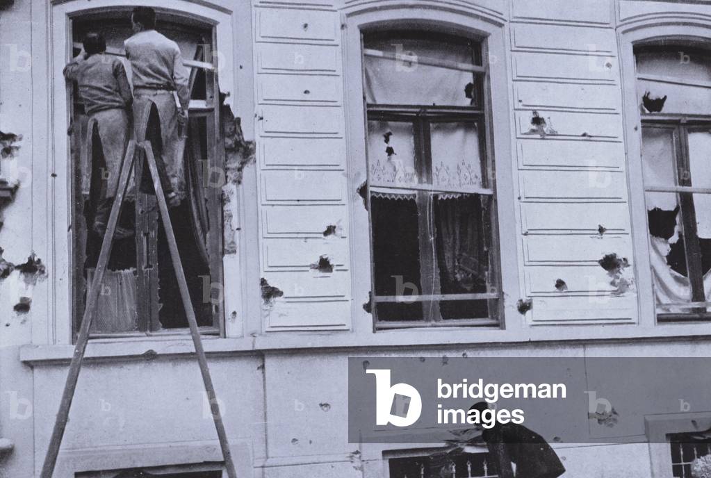 Damage to a building caused by a German bomb dropped from a Zeppelin on Antwerp, Belgium, World War I, August 1914 (b/w photo)