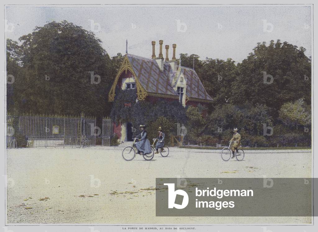 Cyclists riding past the Porte de Madrid in the Bois de Boulogne, Paris (colour photo)