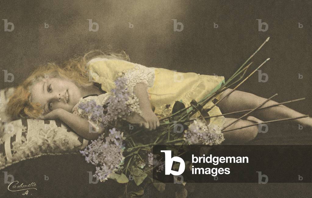 Young girl and flowers (coloured photo)