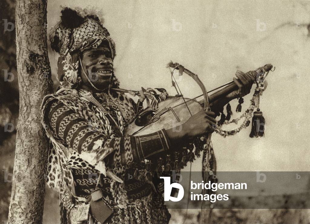 Sudanese man musician, Tunis, 1925 (b/w photo)